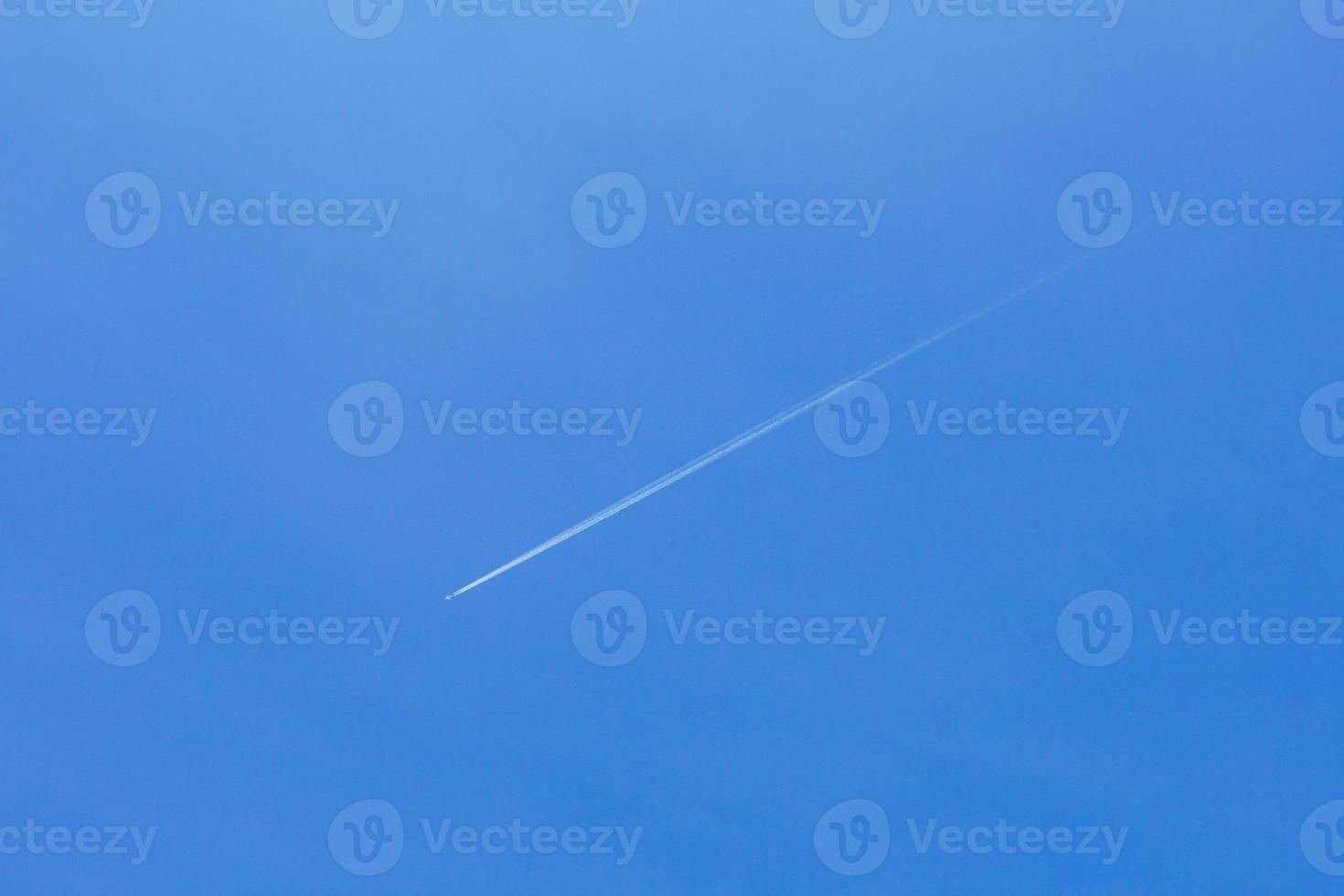 A passenger jet leaves a mark above the blue skies and the start of the airline after the kovic poisoning photo