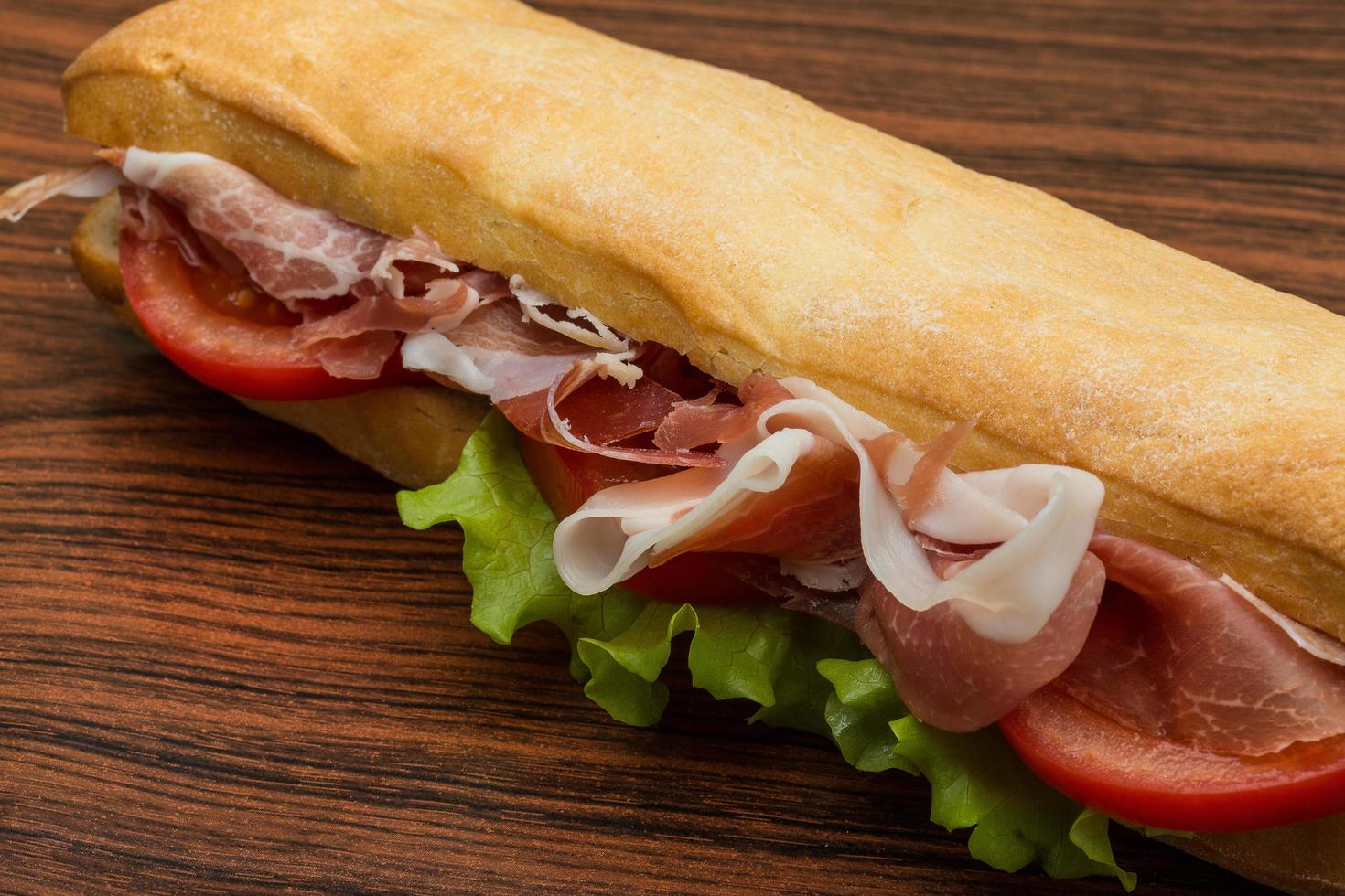 Ham sandwich on wooden background photo
