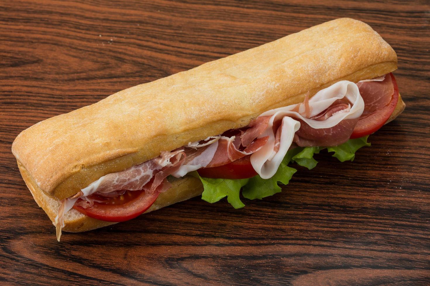 Ham sandwich on wooden background photo