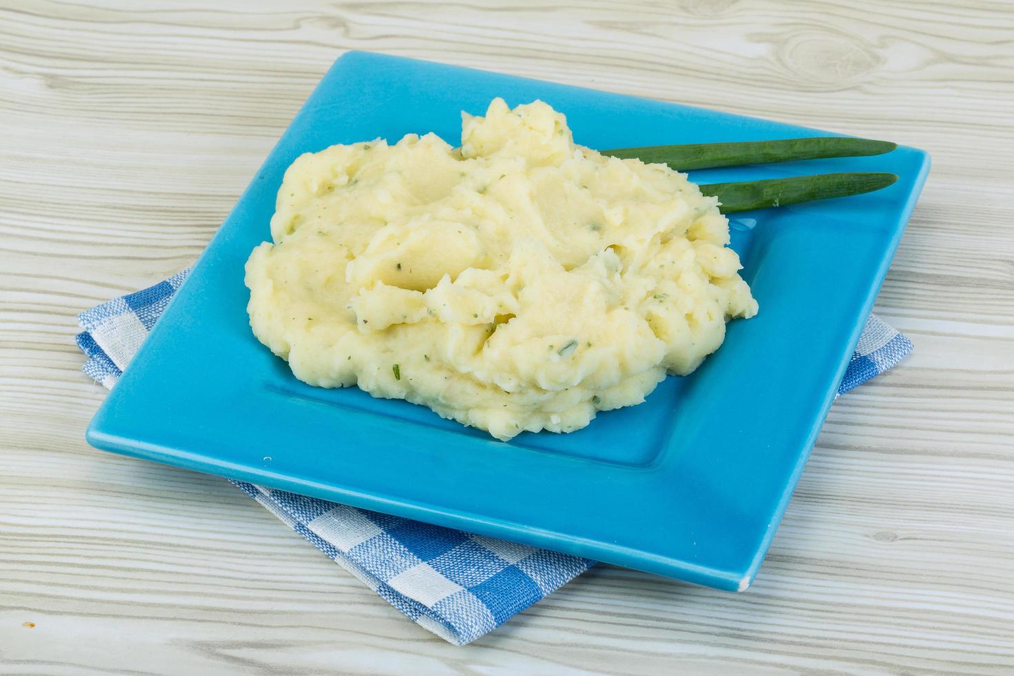 Mash potato on the plate and wooden background photo
