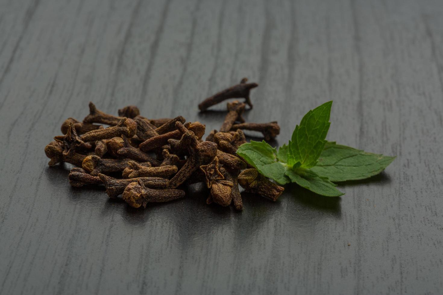 Clove seeds on wooden background photo
