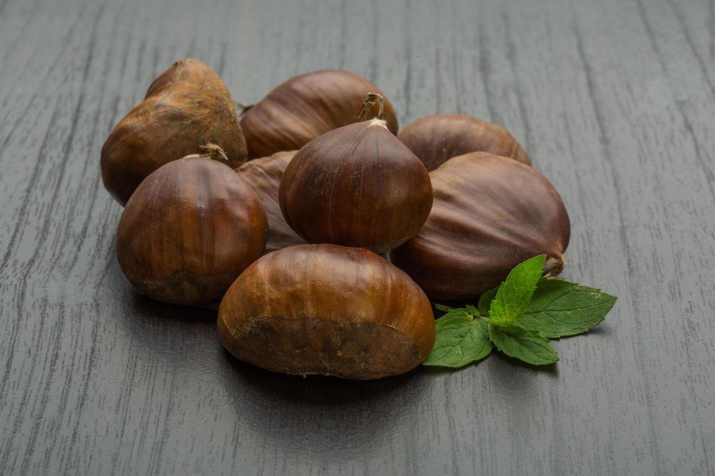 Chestnut on wooden background photo