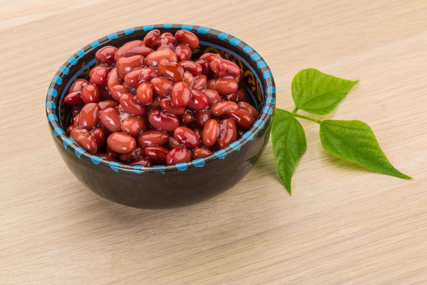 Red beans in a bowl on wooden background photo