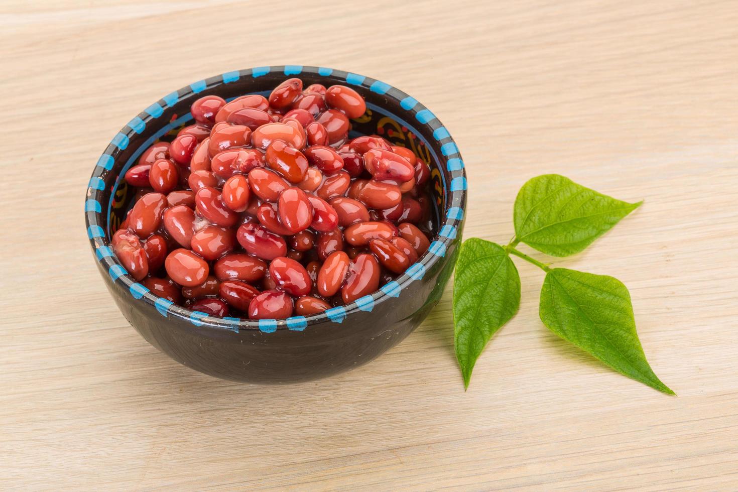 Red beans in a bowl on wooden background photo