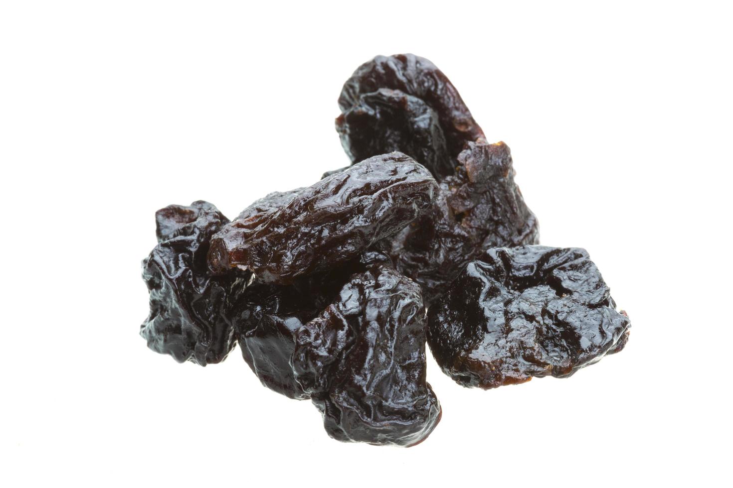 Ripe prunes on white background photo