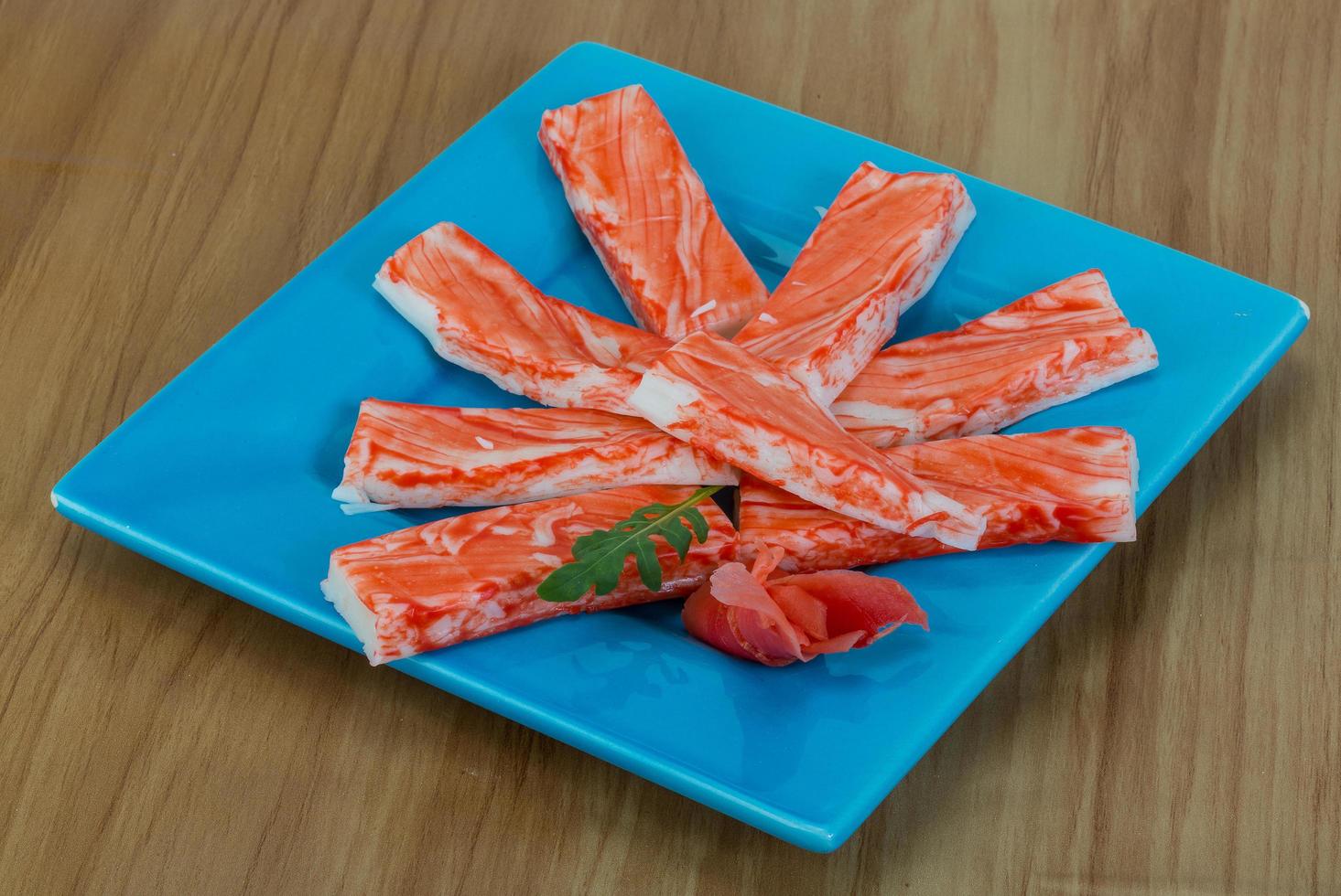 Crab sticks on the plate and wooden background photo