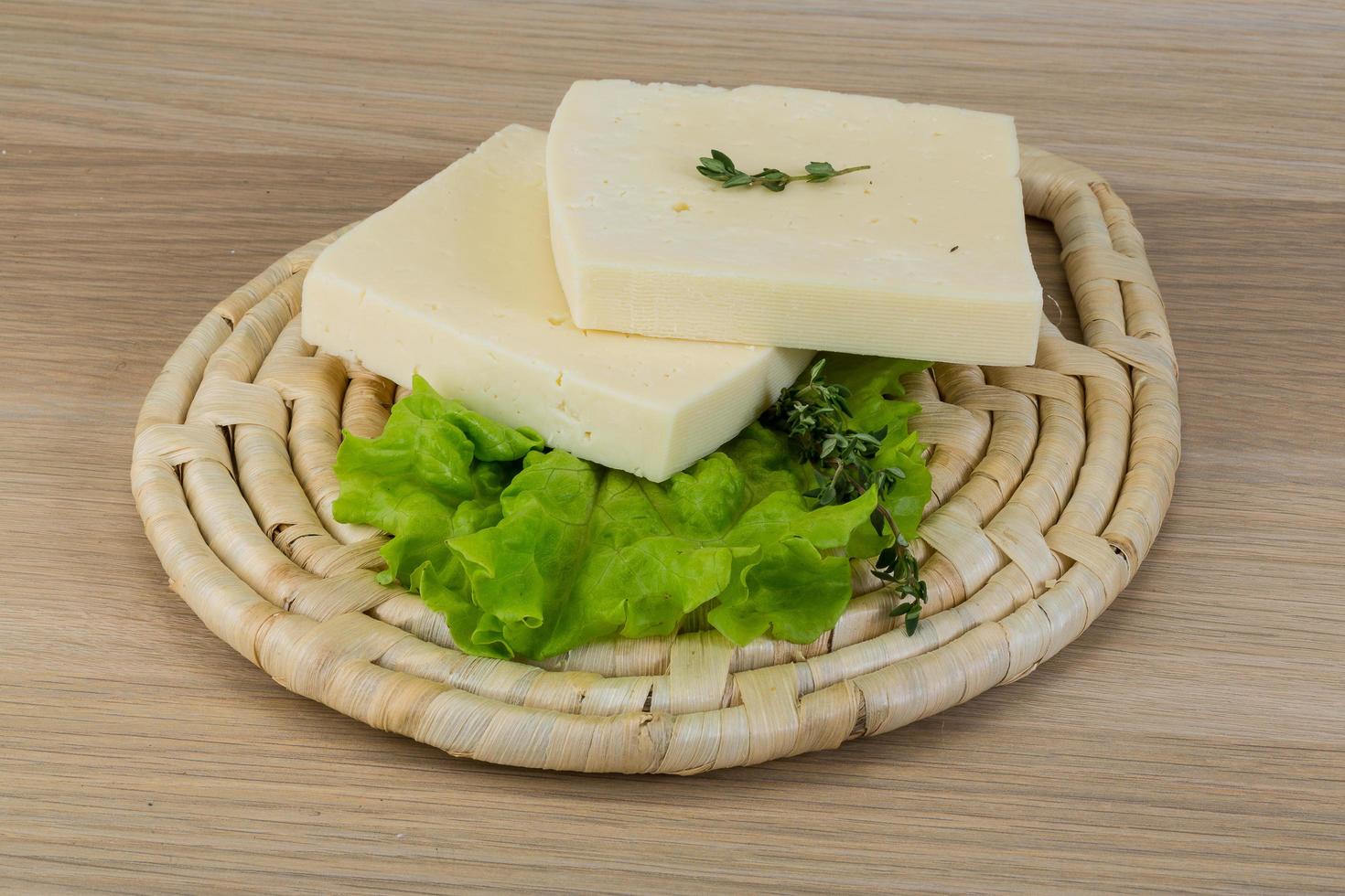 Yellow cheddar on wooden board and wooden background photo