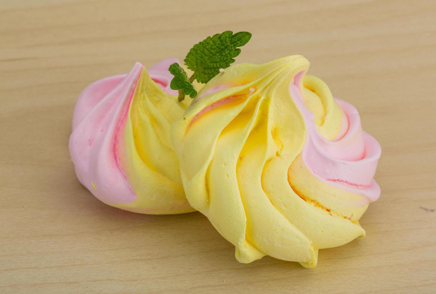 Meringue on wooden background photo