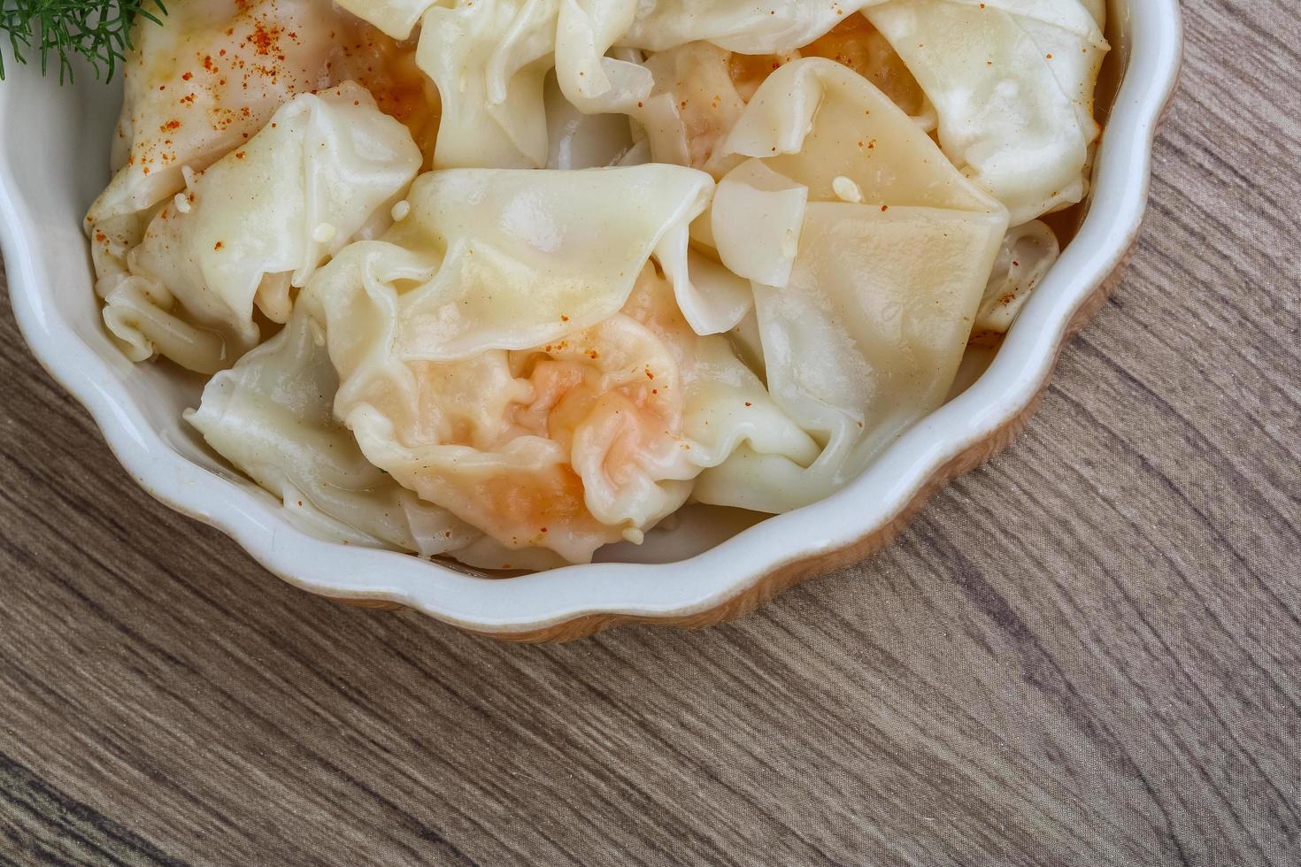Shrimp wanton in a bowl on wooden background photo
