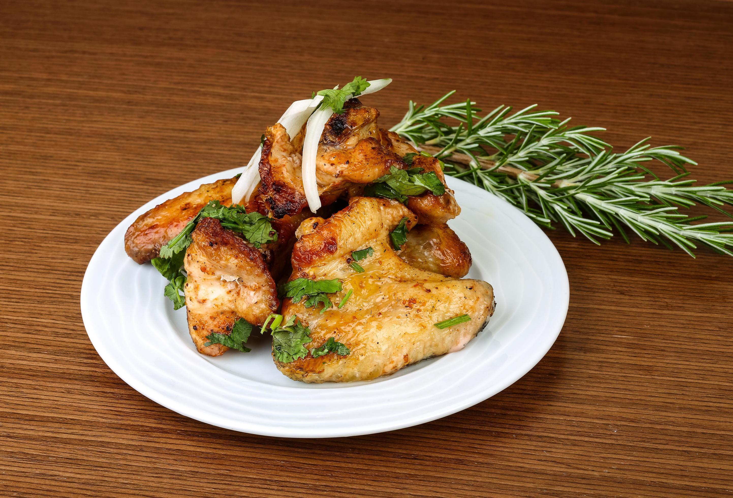 Chicken wings on the plate and wooden background 12530845 Stock Photo