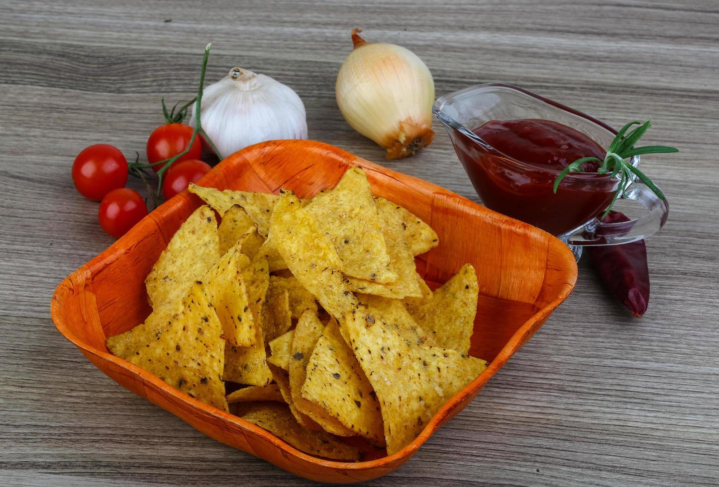 Nachos in a bowl on wooden background photo