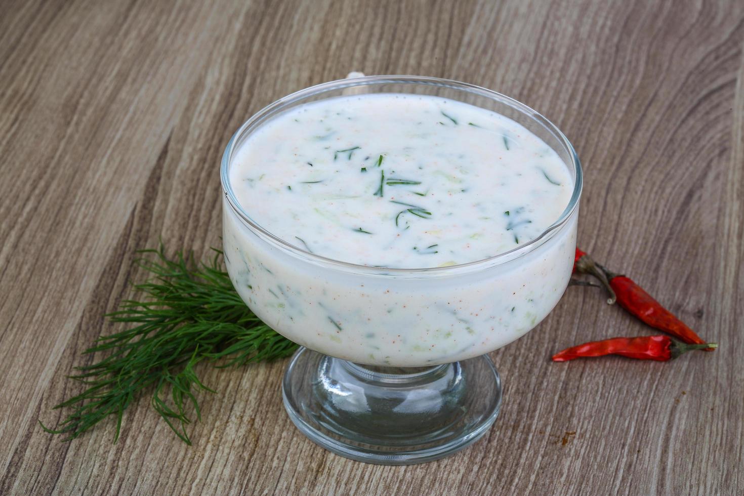 Tzatziki in a bowl on wooden background photo