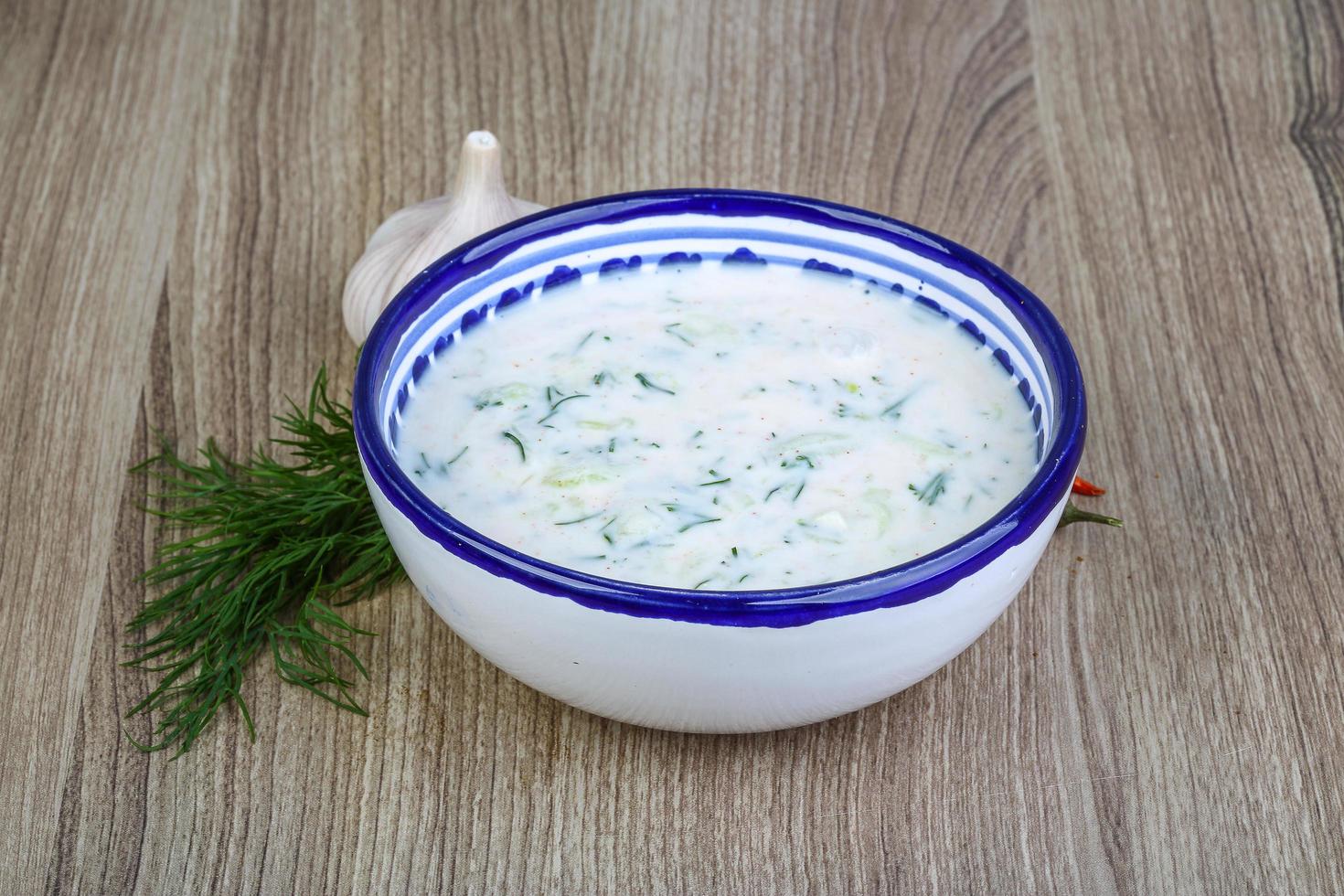 Tzatziki in a bowl on wooden background photo