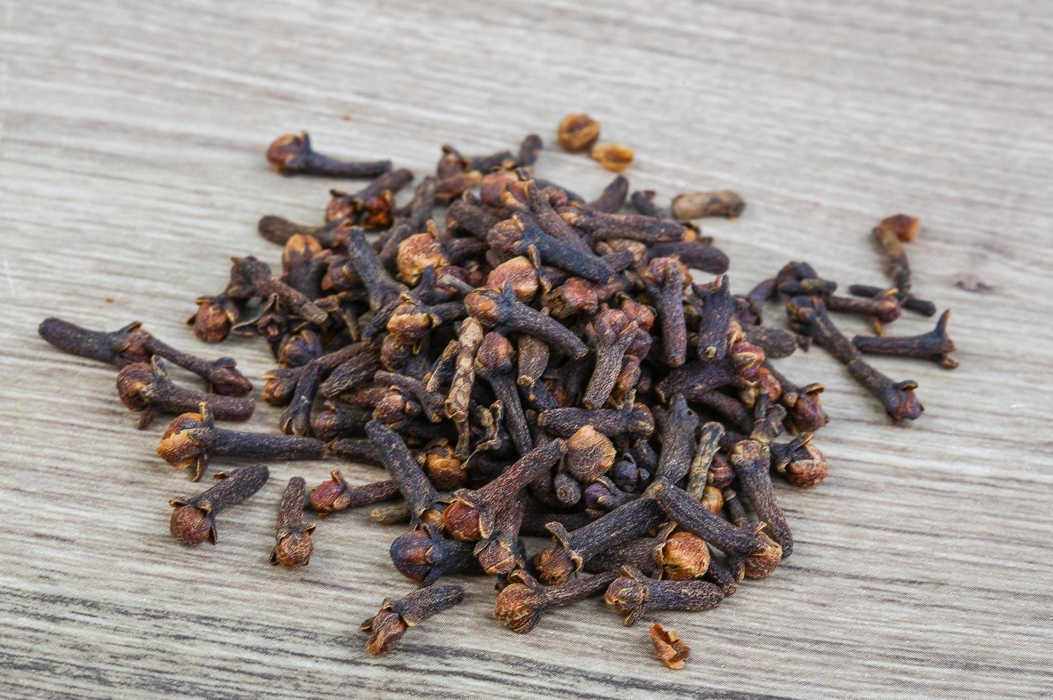 Cloves seeds on wooden background photo