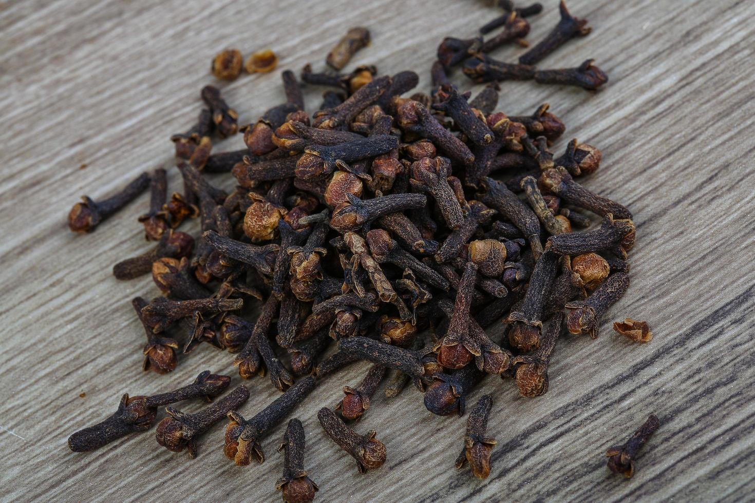 Cloves seeds on wooden background photo