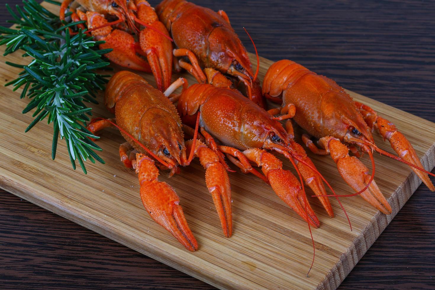 Crayfish on wooden board and wooden background photo