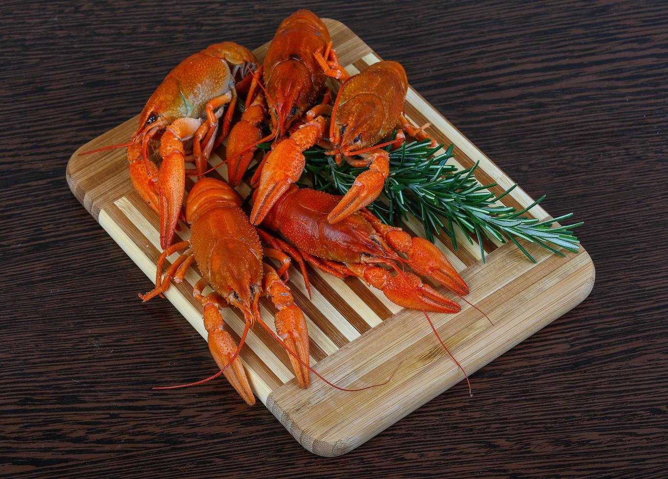 Crayfish on wooden board and wooden background photo