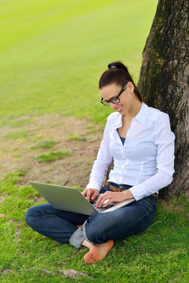 woman with laptop in park photo