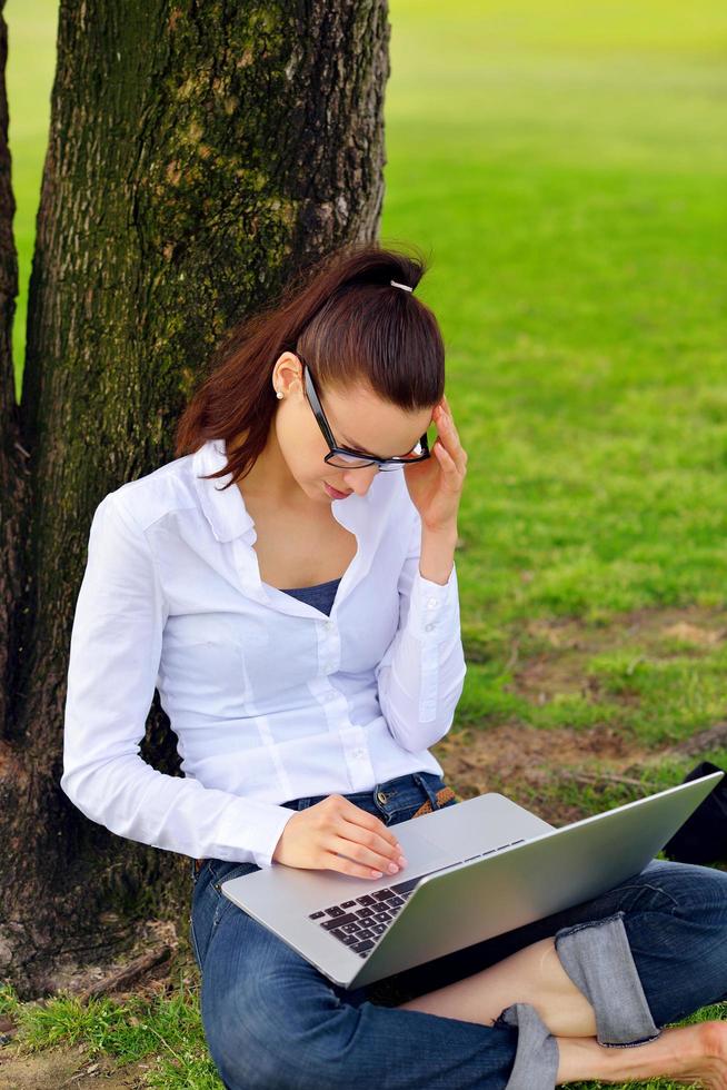woman with laptop in park photo