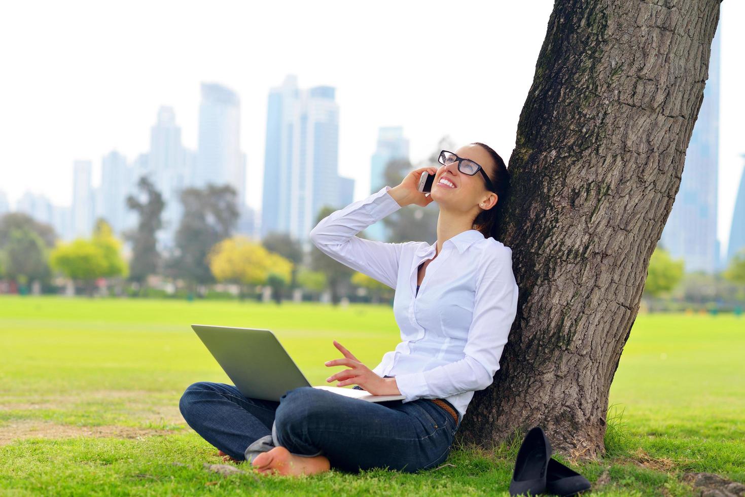 woman with laptop in park photo