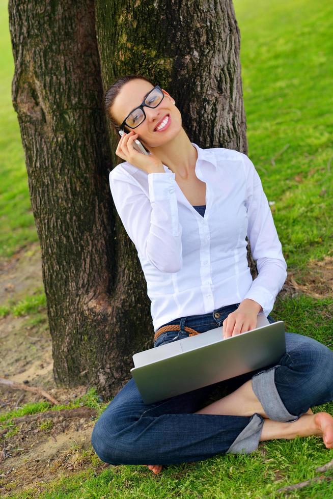 woman with laptop in park photo