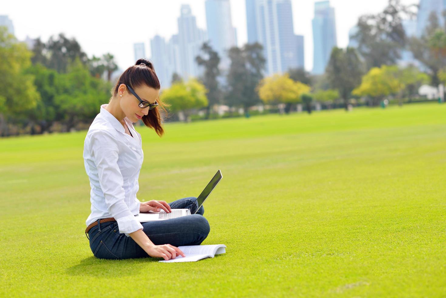 woman with laptop in park photo