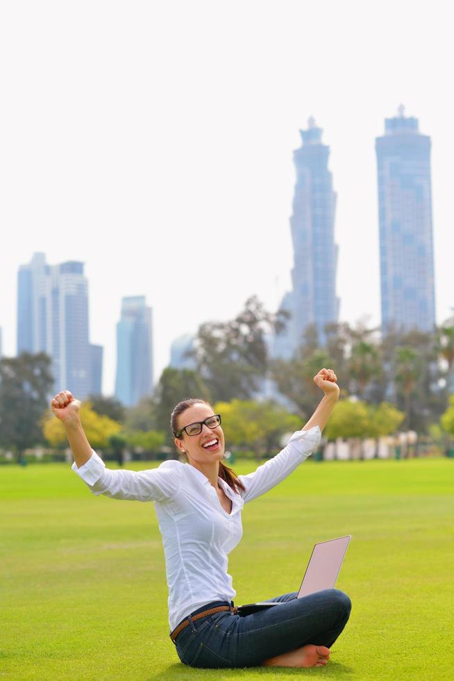 woman with laptop in park photo