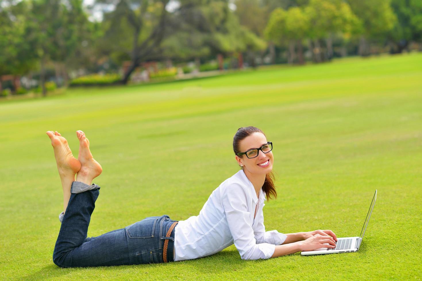 woman with laptop in park photo