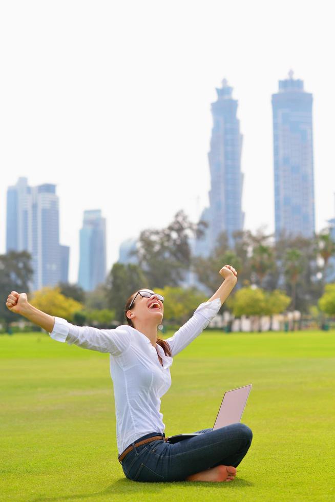 woman with laptop in park photo