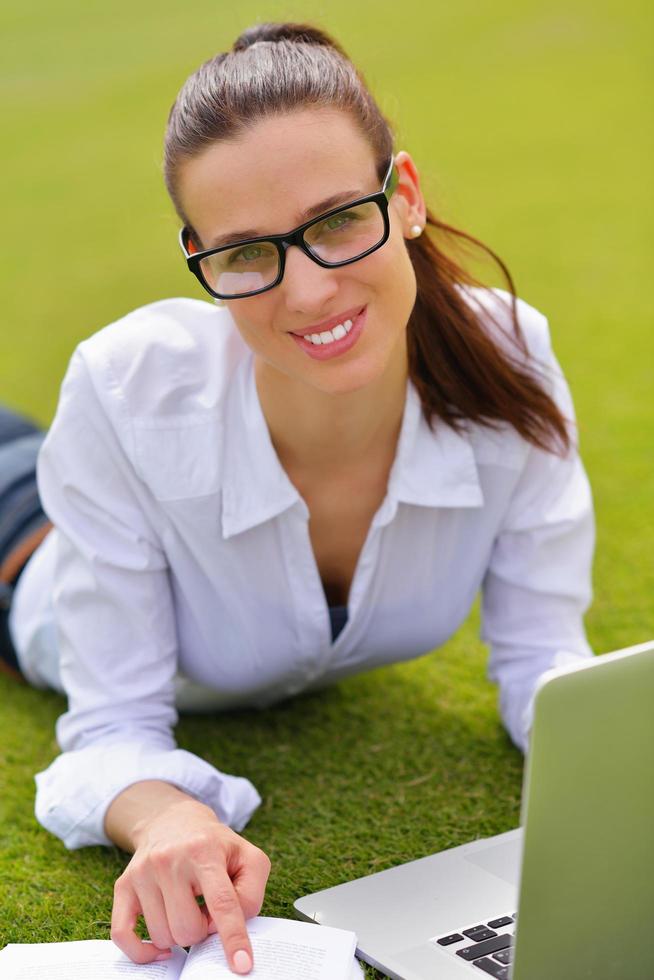 woman with laptop in park photo