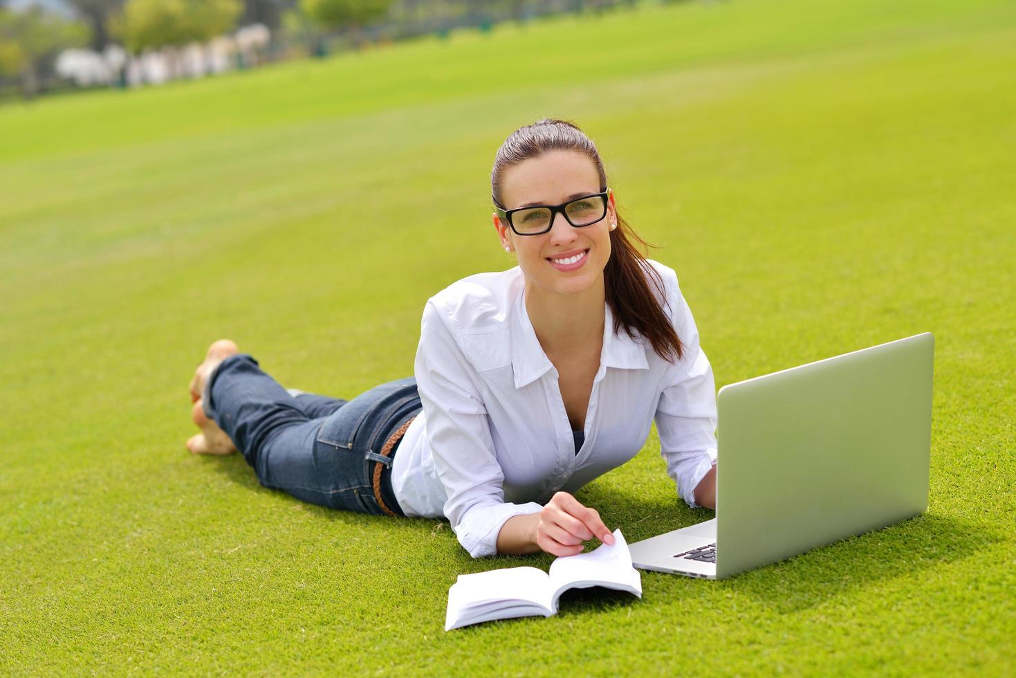 woman with laptop in park photo