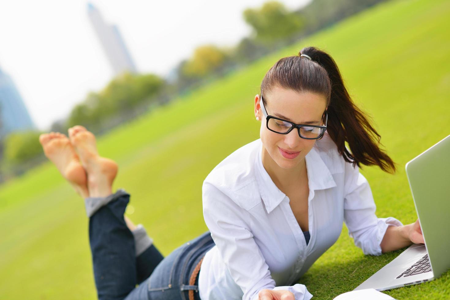 woman with laptop in park photo