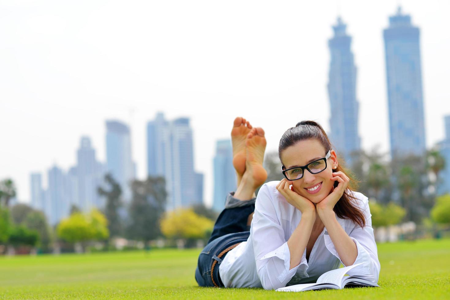 Young woman reading a book in the park photo