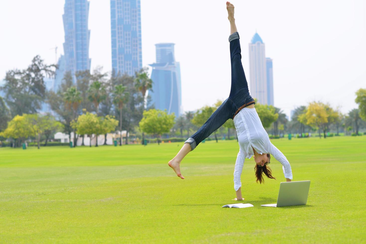 woman with laptop in park photo