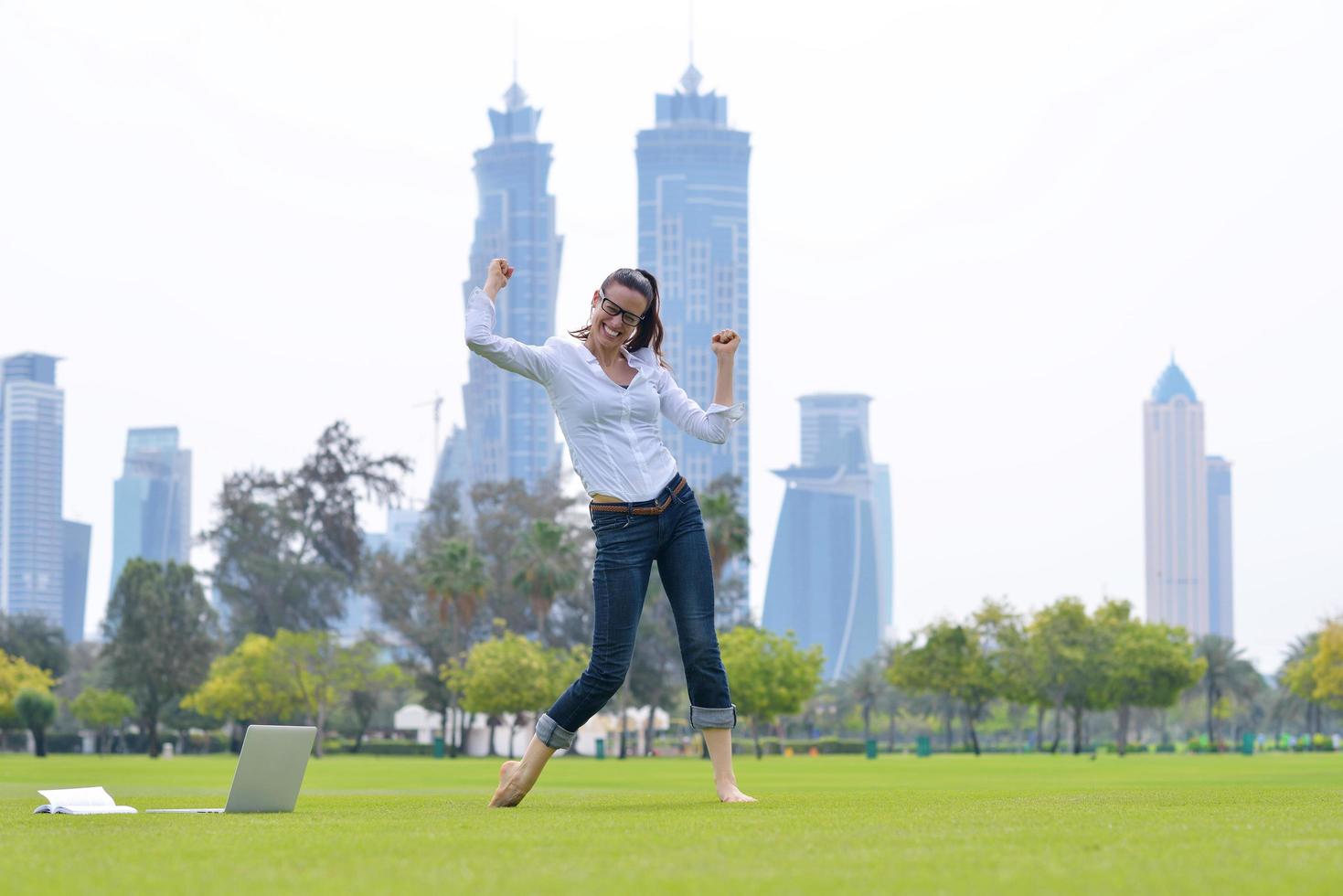 woman with laptop in park photo