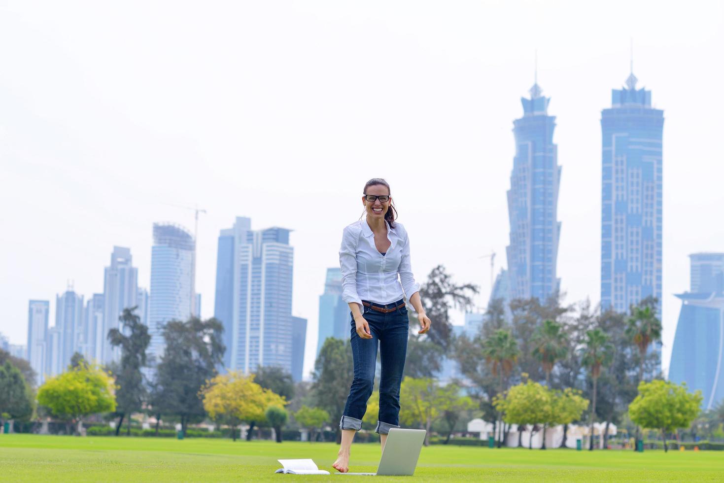 woman with laptop in park photo