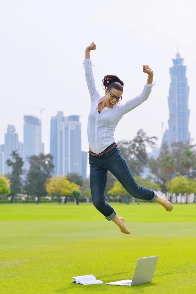 woman with laptop in park photo