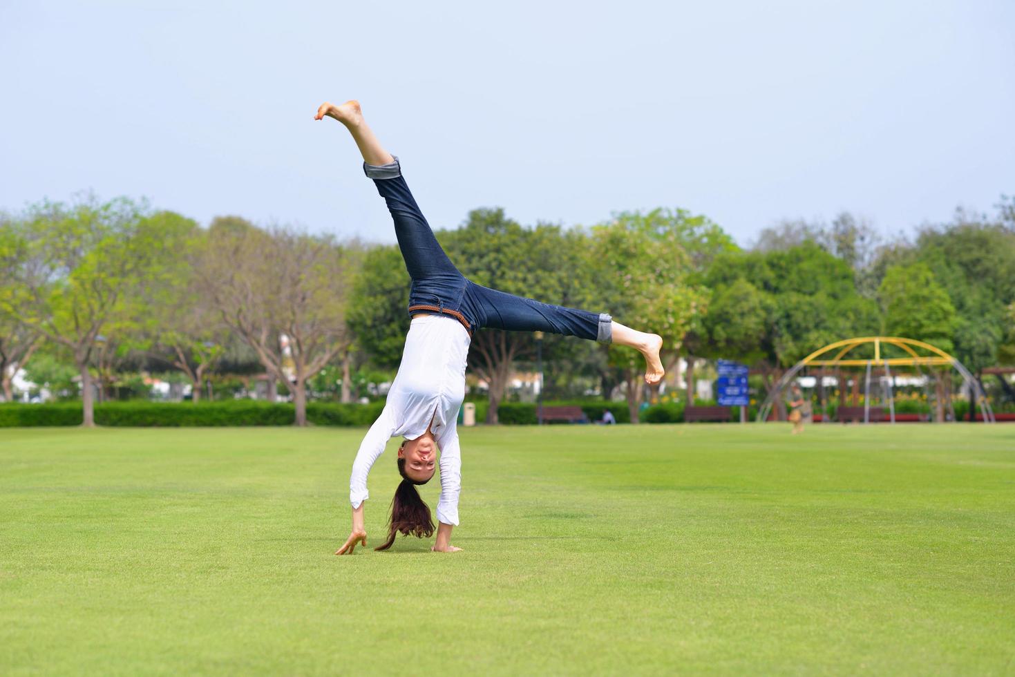 young woman jumping in park photo