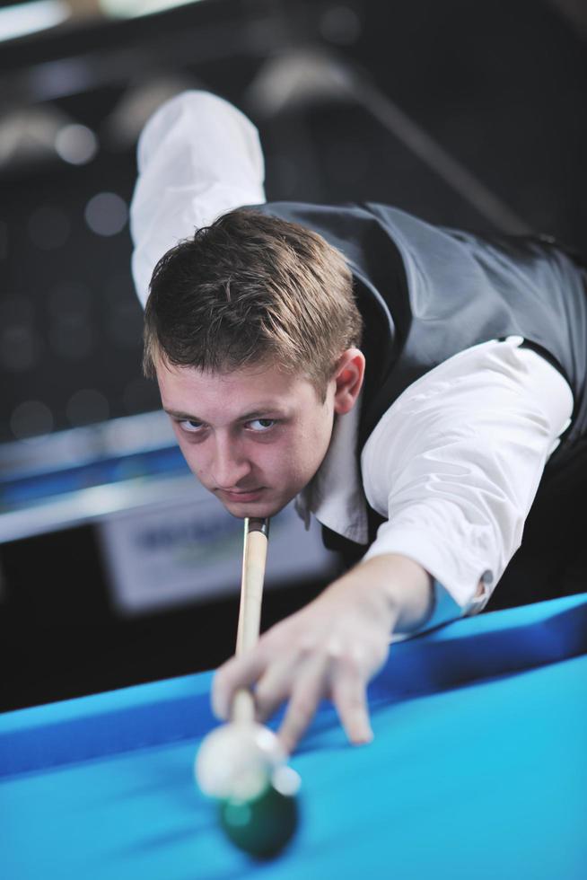 young man play pro billiard game photo