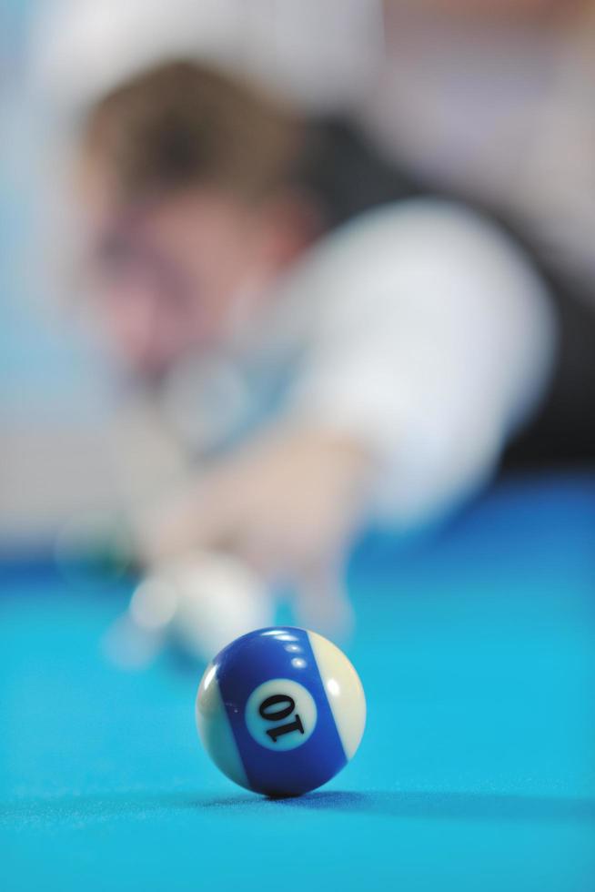 young man play pro billiard game photo