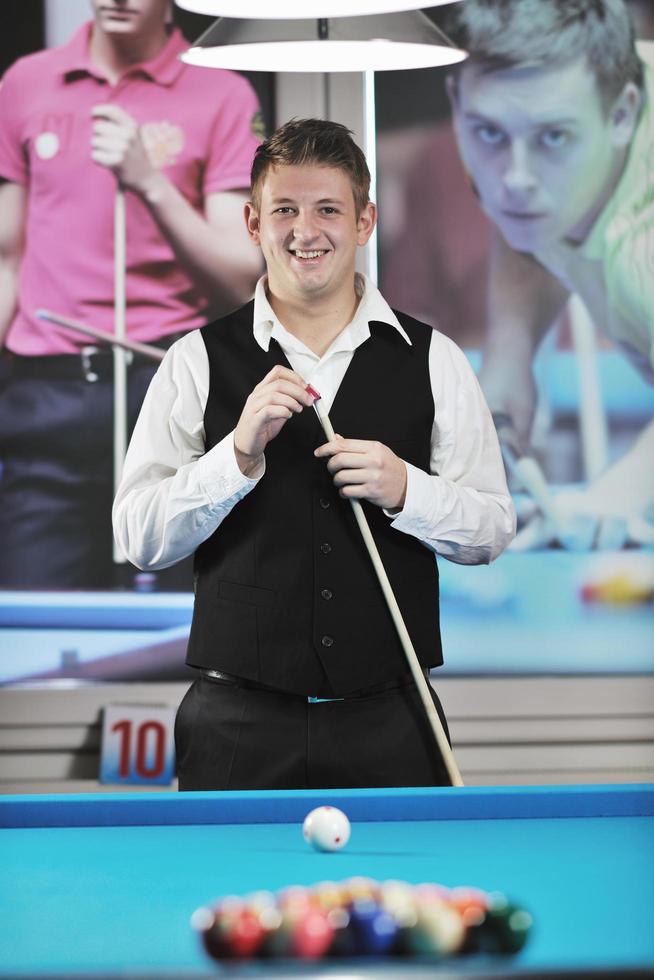 young man play pro billiard game photo