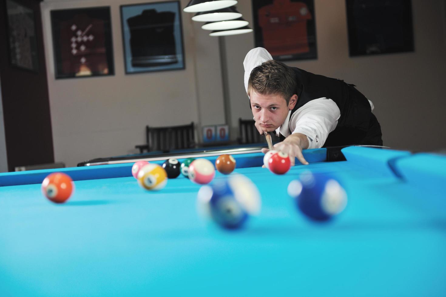 young man play pro billiard game photo