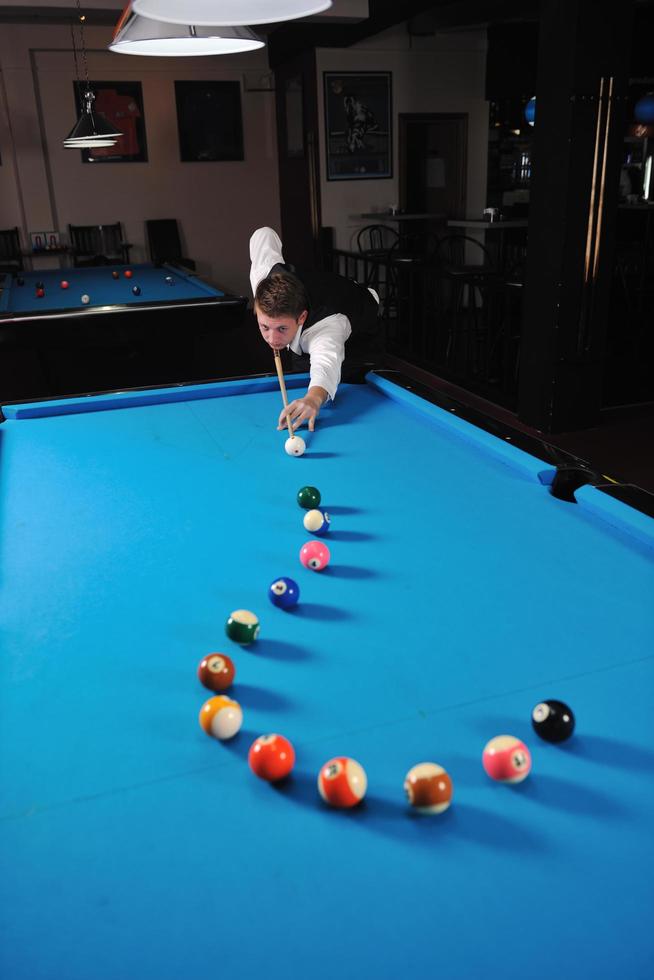 young man play pro billiard game photo