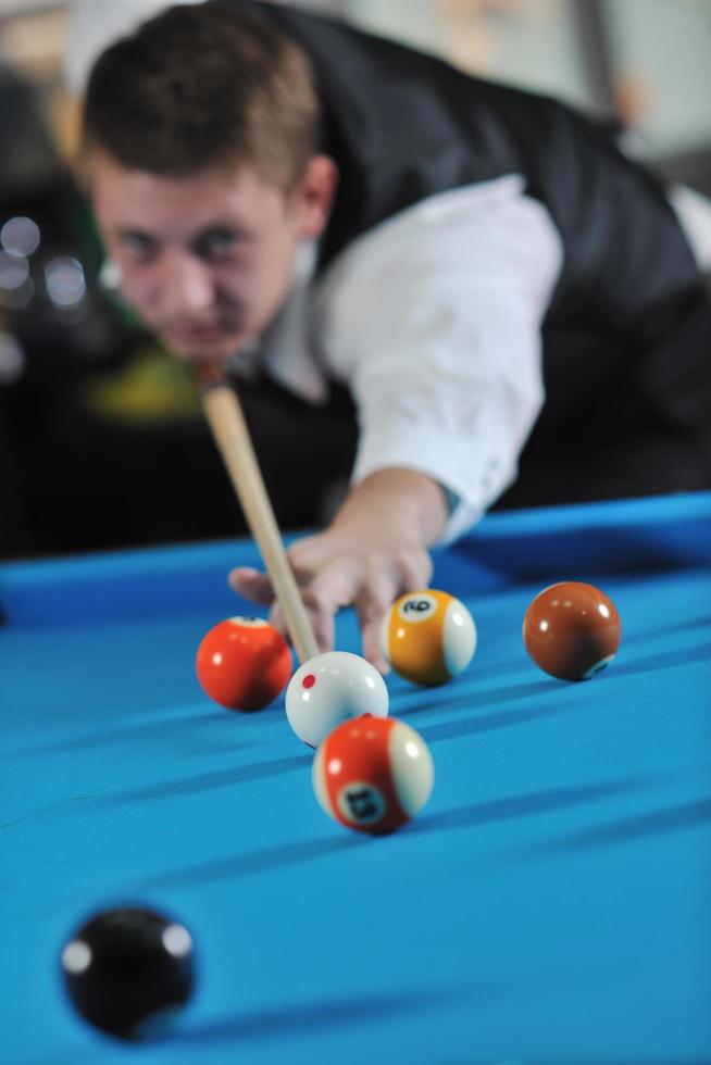 young man play pro billiard game photo