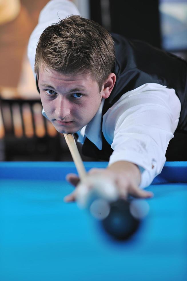 young man play pro billiard game photo