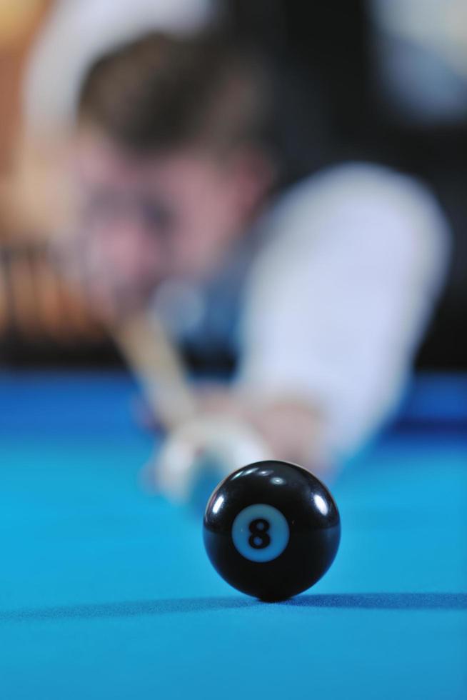 young man play pro billiard game photo