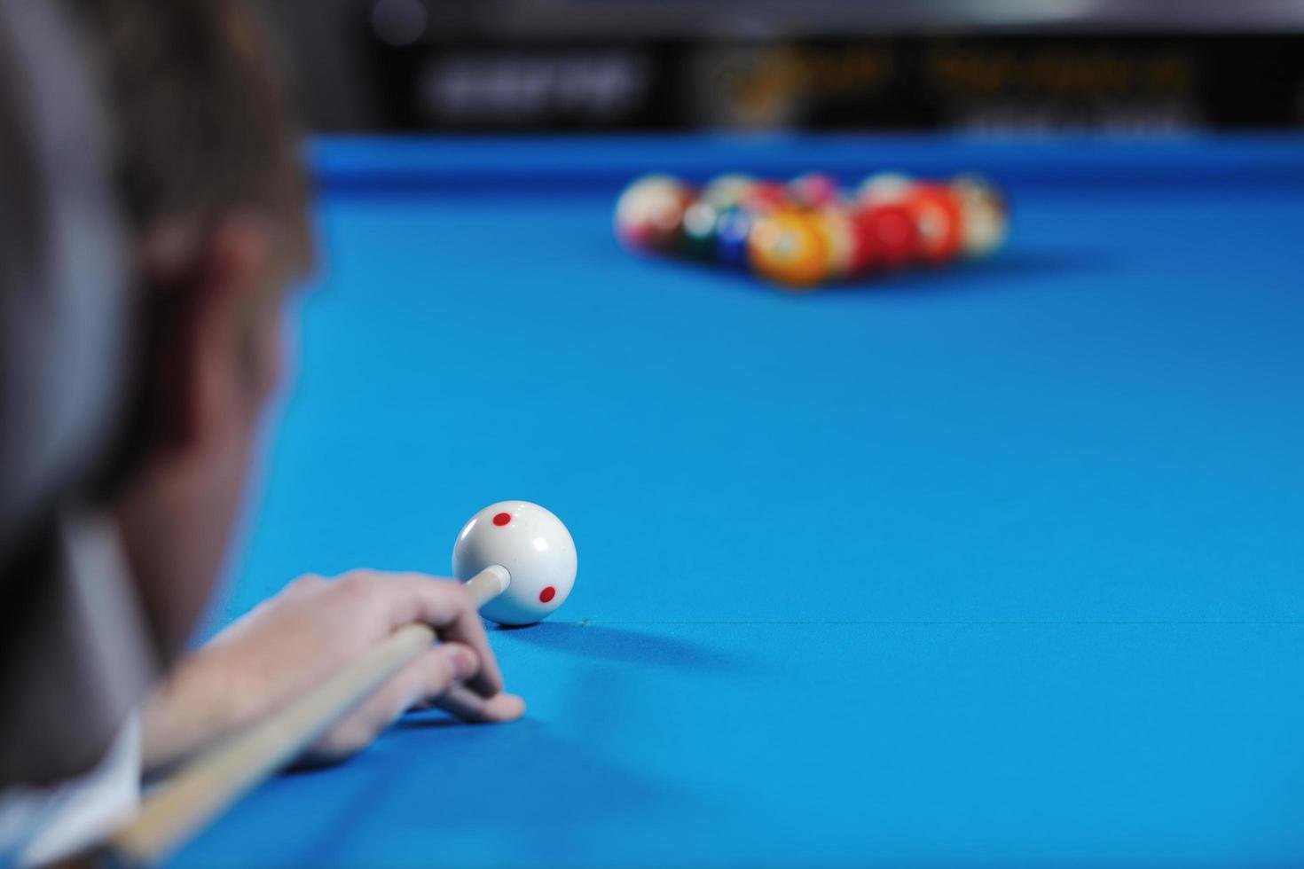 young man play pro billiard game photo