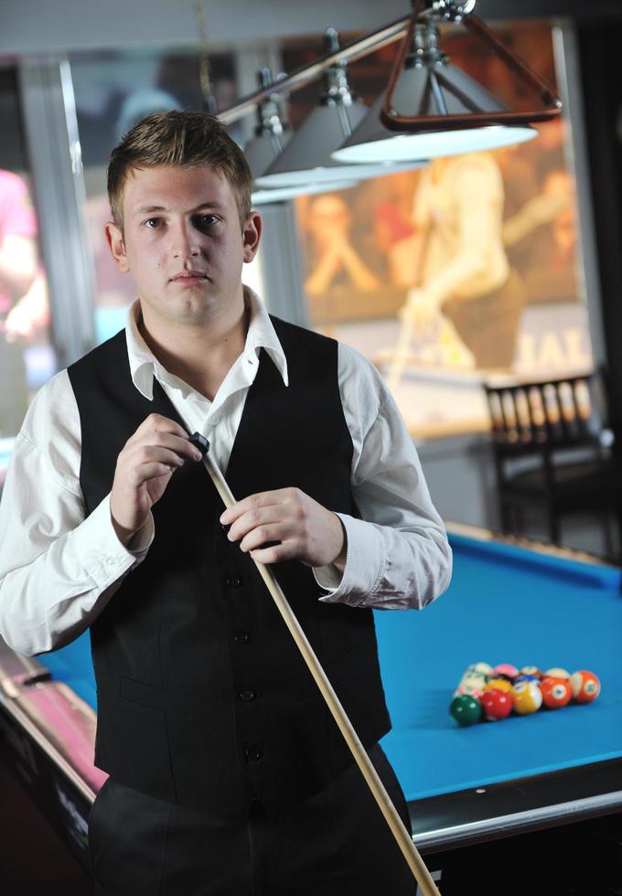 young man play pro billiard game photo