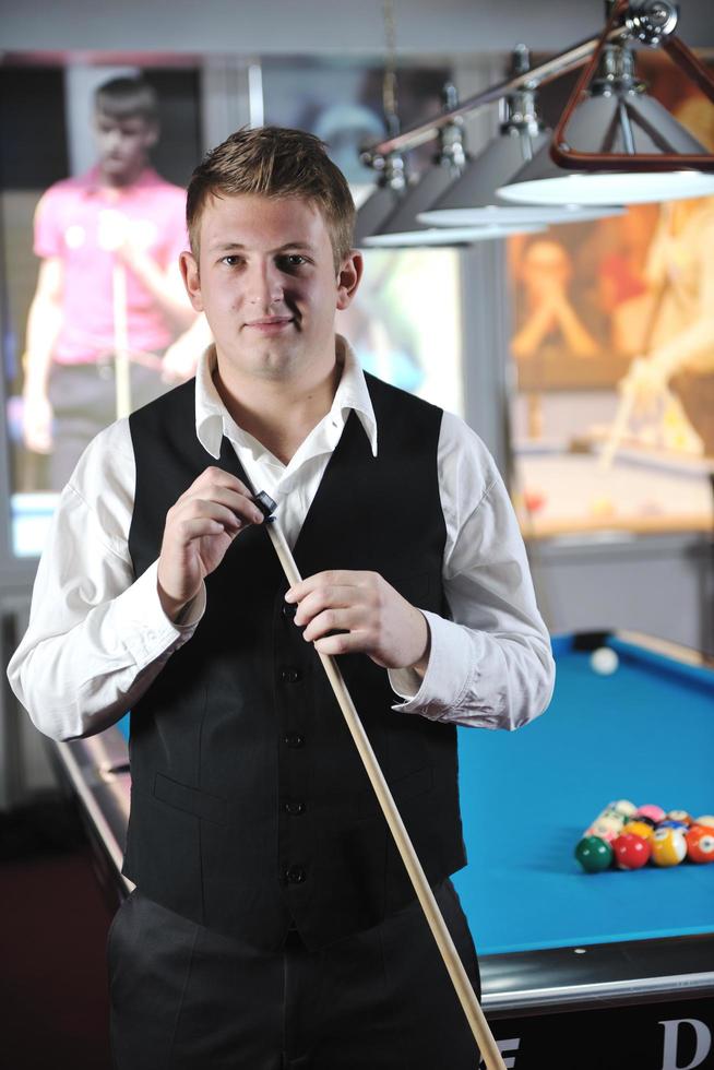 young man play pro billiard game photo