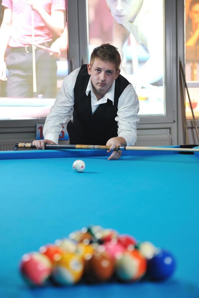 young man play pro billiard game photo